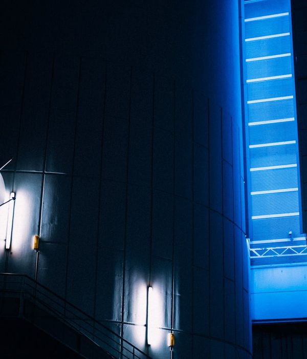 Abstract blue neon geometric structures in a dark space