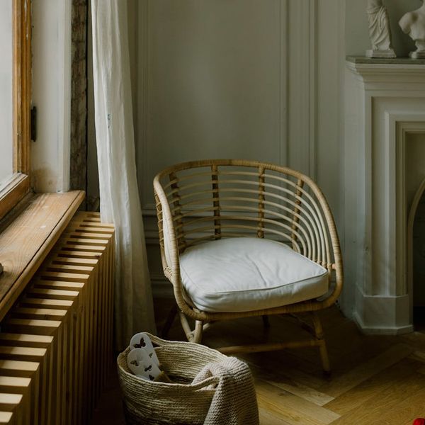 Cozy corner of a room with a yoga mat, a plant, and soft light.
