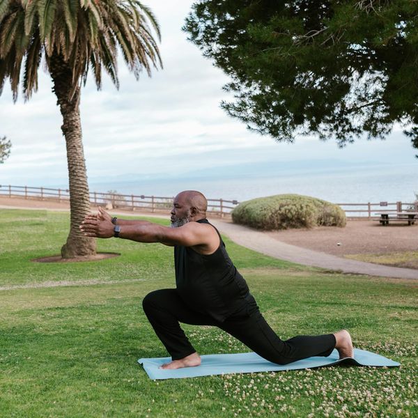 Person in a gentle stretching yoga pose on a mat.