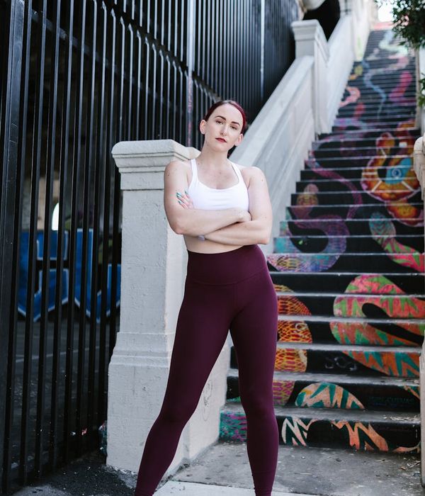 Person in an energetic yoga warrior pose outdoors at sunrise.